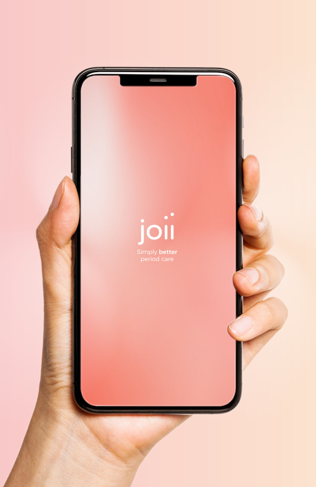 Pale pink and peach gradient background. Hand holding a smartphone displaying the Joii app home screen